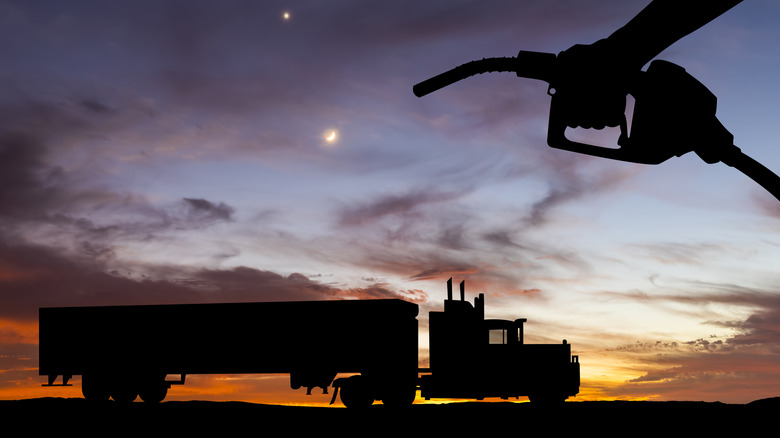 shadow of diesel fuel pump and truck at night