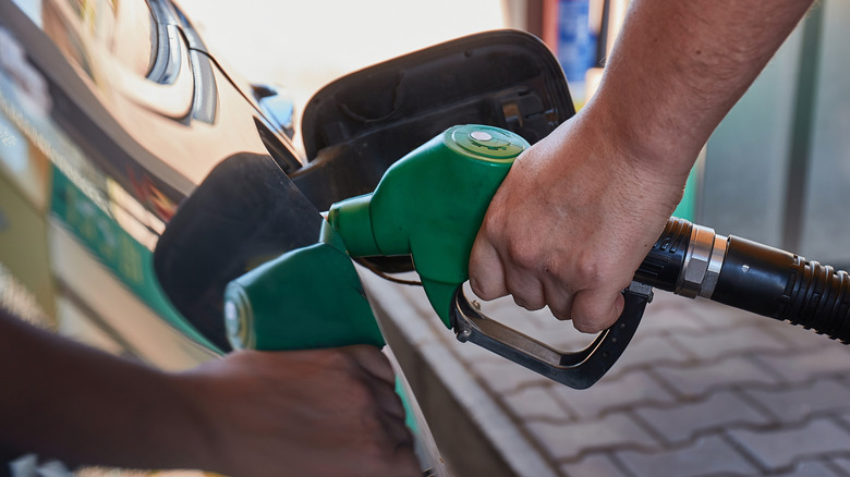 man pumping diesel fuel