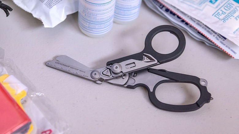 Raptor Rescue scissors on a desk with medical supplies.