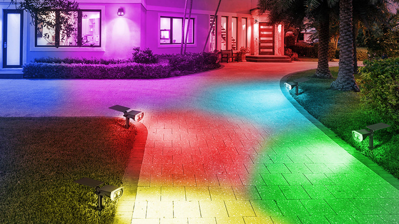 Series of multicolored spotlights illuminating an outdoor wall