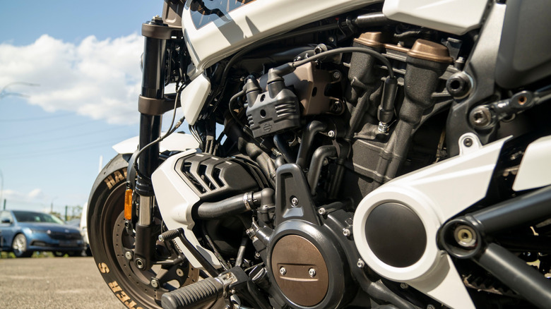 White motorcycle with engine up close