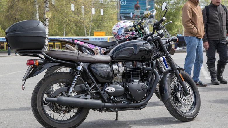 Black Triumph T120 in parking lot