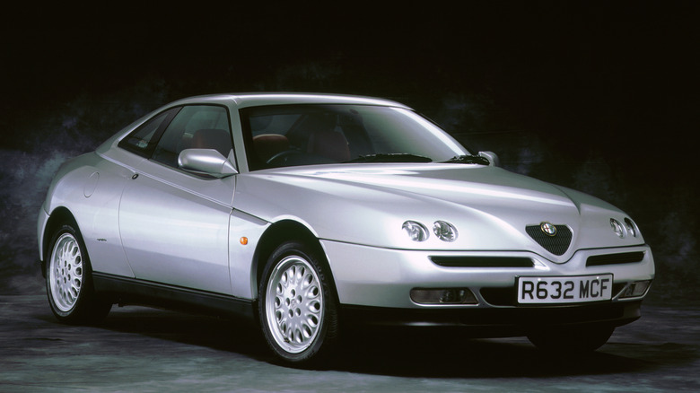 The 916 Alfa Romeo GTV in silver with teledial wheels, front 3/4 view