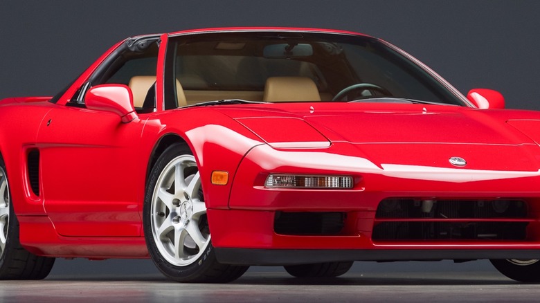 A red NA1 Acura NSX, front 3/4 view, studio shot