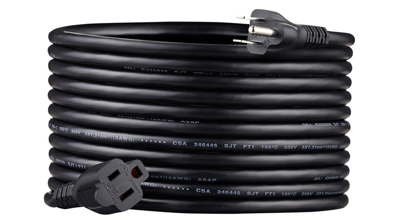 Coil of black power cord showing both male and female ends