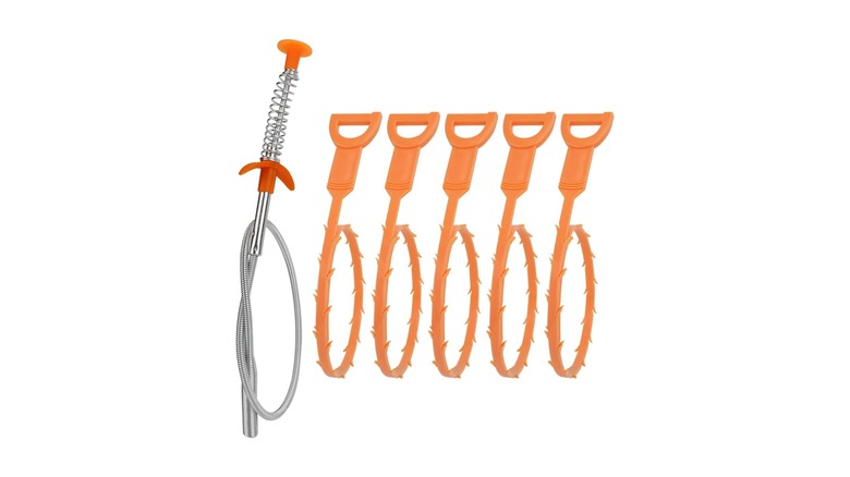 Metal hose-like device with plastic orange end and spring handle and five orange devices