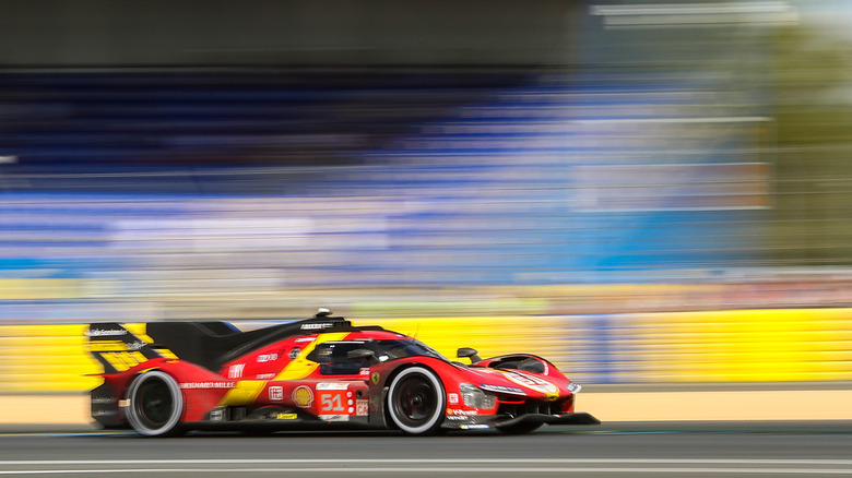 Ferrari 499P hypercar driving on a track