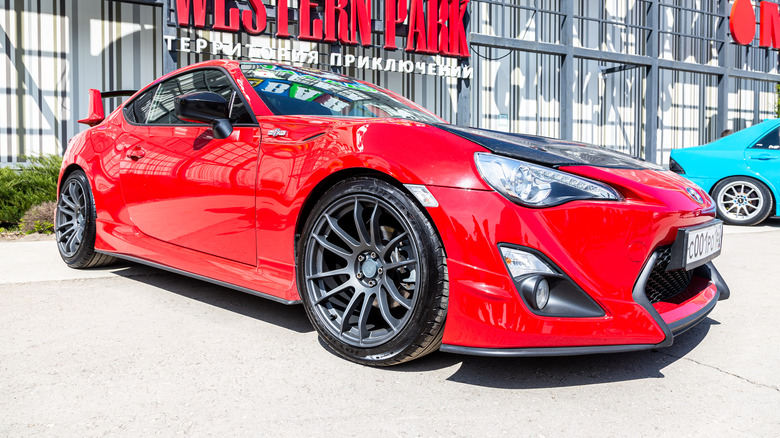 A red Toyota outside of a stadium