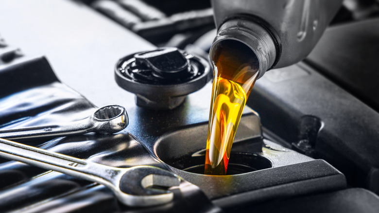 Motor oil being poured into an engine.