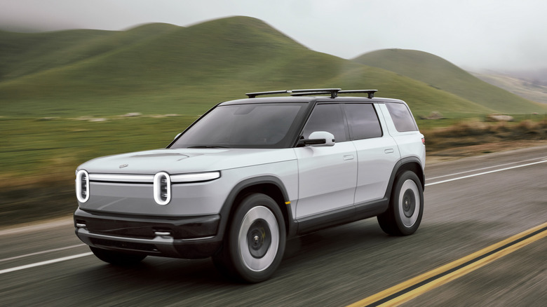 The Rivian R2 driving, front 3/4 view