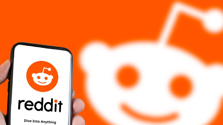 Reddit logo on phone and in background