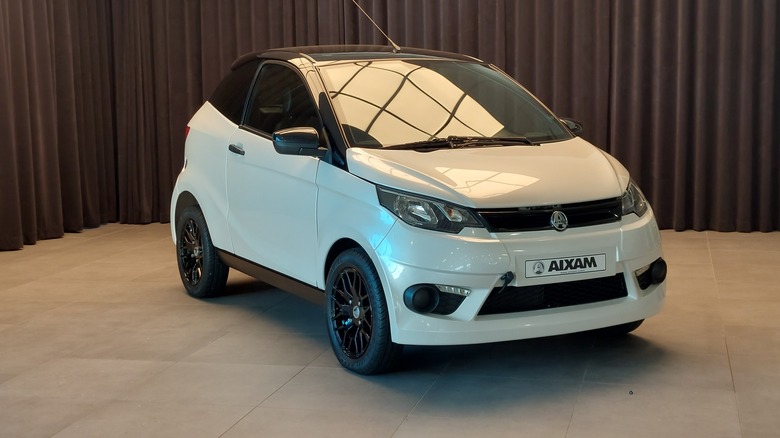 An Aixam microcar in white, front 3/4 view