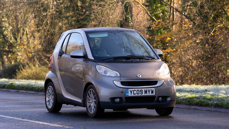 The Smart Fortwo in bronze driving, front 3/4 view