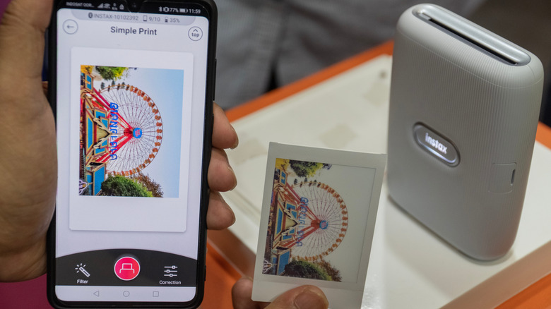 A smartphone with an Instax Bluetooth printer and a printout of an image