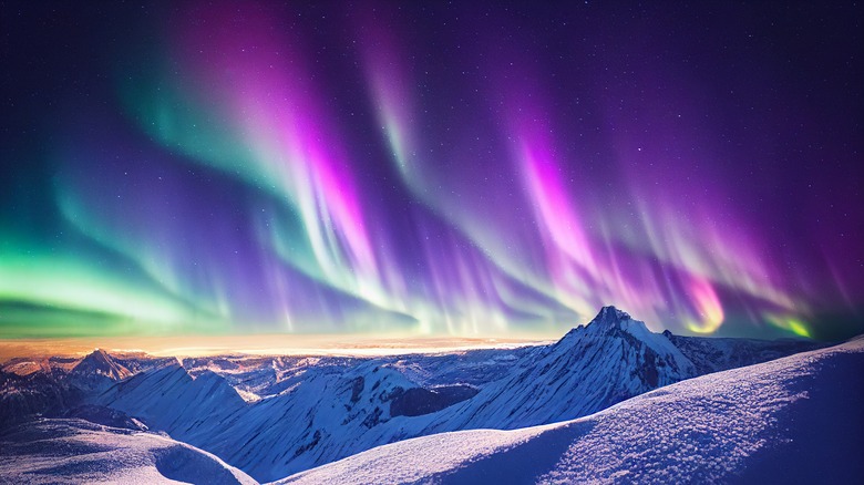 Aurora Borealis over snowy mountains