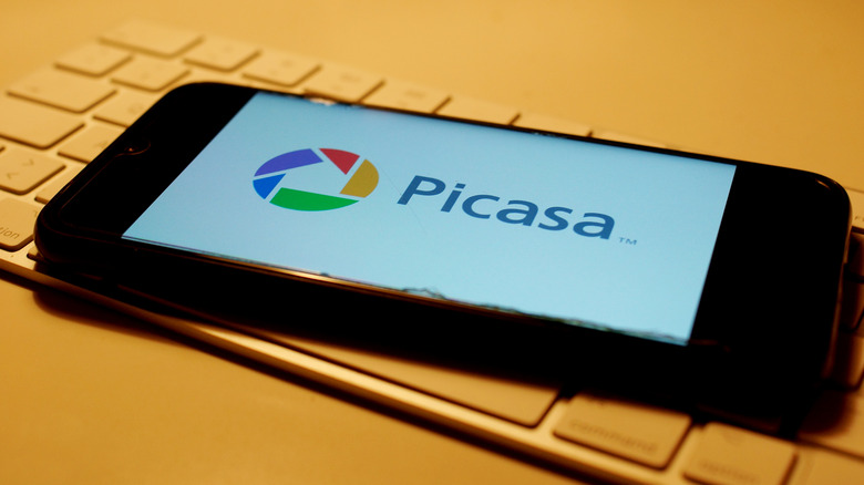 Closeup of smartphone screen with logo lettering of Picasa