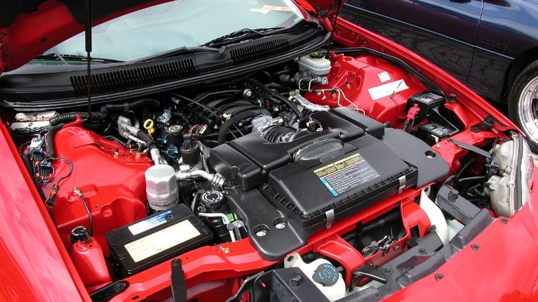 A Cheverolet Camaro Z28 engine in a red car.