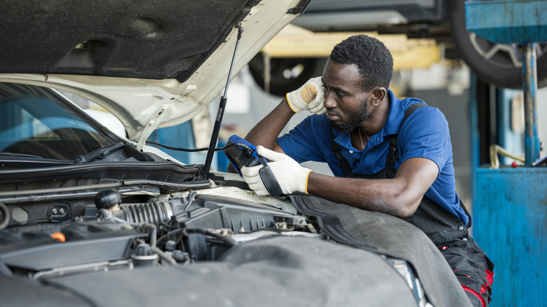 a mechanic working on an engine