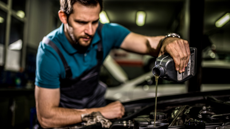 Mechanic changing car oil