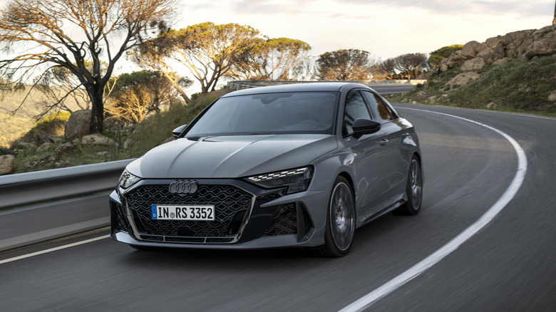 The 2025 Audi RS3 in gray on the move, front 3/4 view