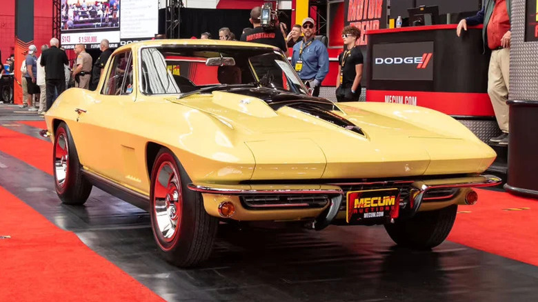 A pale yellow Chevrolet Corvette L88 is on display.