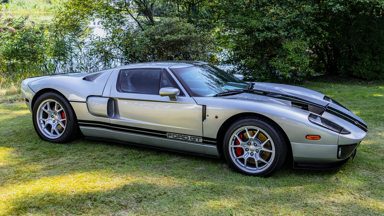 A silver Ford GT is parked on grass.