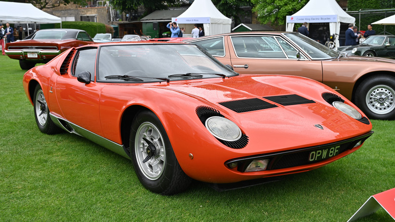 A red Lamborghini Miura is on display.