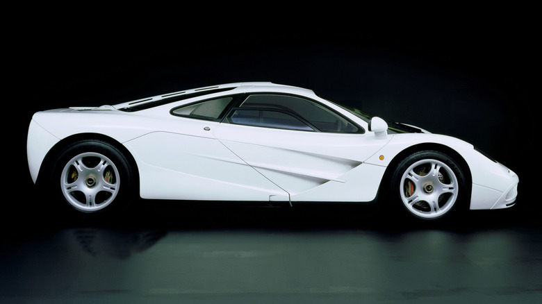 A white McLaren F1 is shown with a black background.