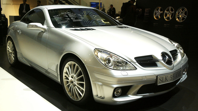 A silver Mercedes-Benz SLK 55 AMG at an auto show, front 3/4 view