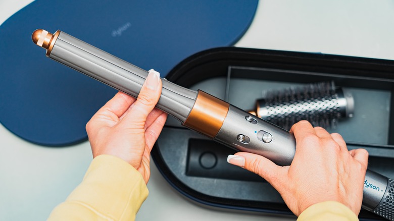 woman holding Dyson Airwrap