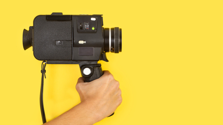 Hand holding a Super 8 camcorder