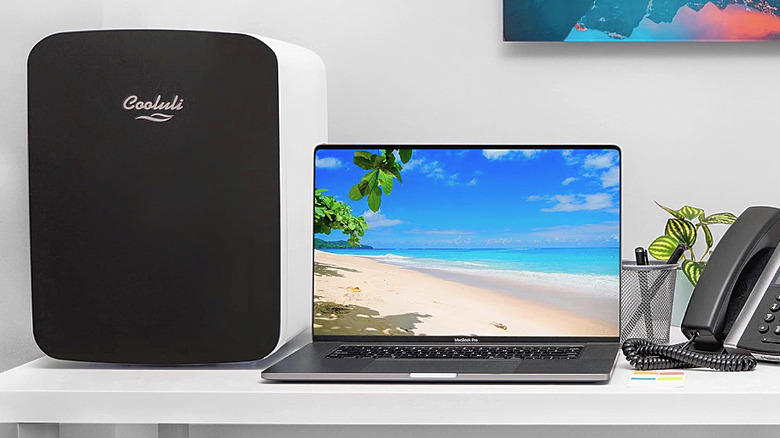 A Cooluli Mini Fridge next to a laptop.