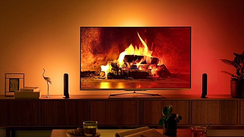 The Philips Hue Play Light Bar extending the colors of an on-screen fireplace.