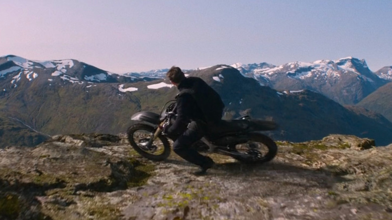 Ethan Hunt on motorcycle overlooking cliff