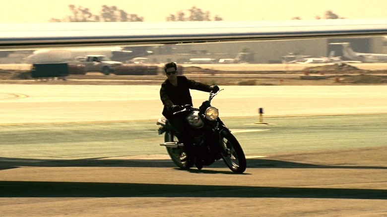 Ethan Hunt riding Triumph motorcycle on airstrip