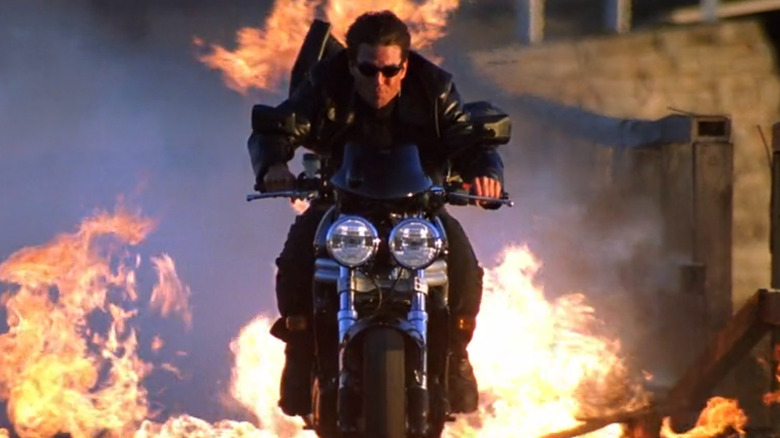 Ethan Hunt riding motorcycle through flames