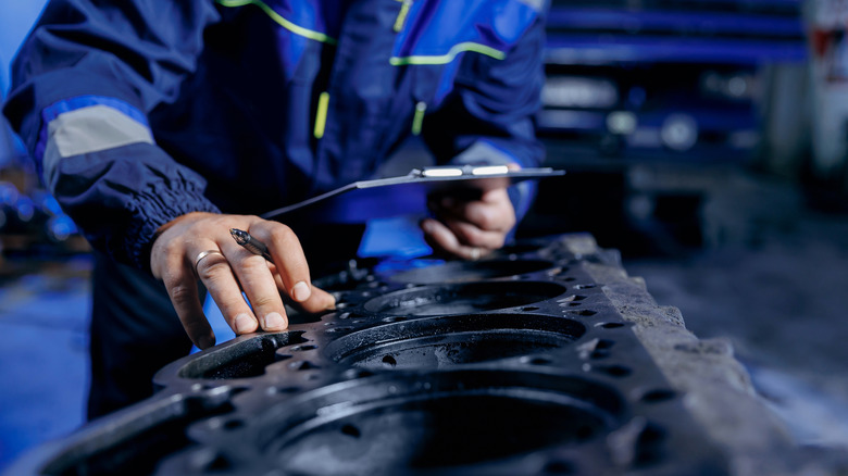 Mechanic inspects diesel engine