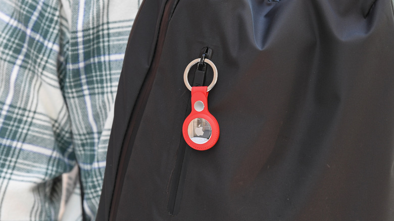 An Apple AirTag attached to a rucksack.