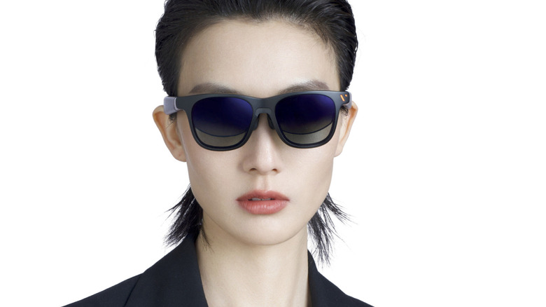 A woman modeling a pair of Viture Pro XR Glasses.