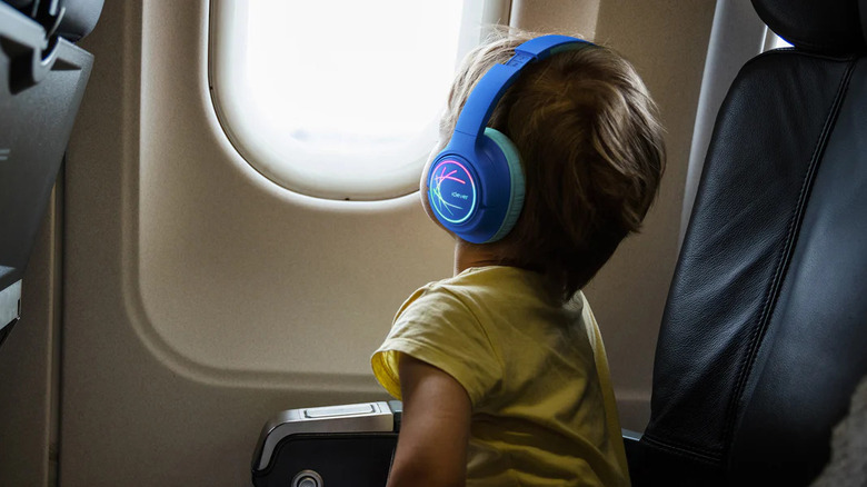 A child wearing headphones on a plane