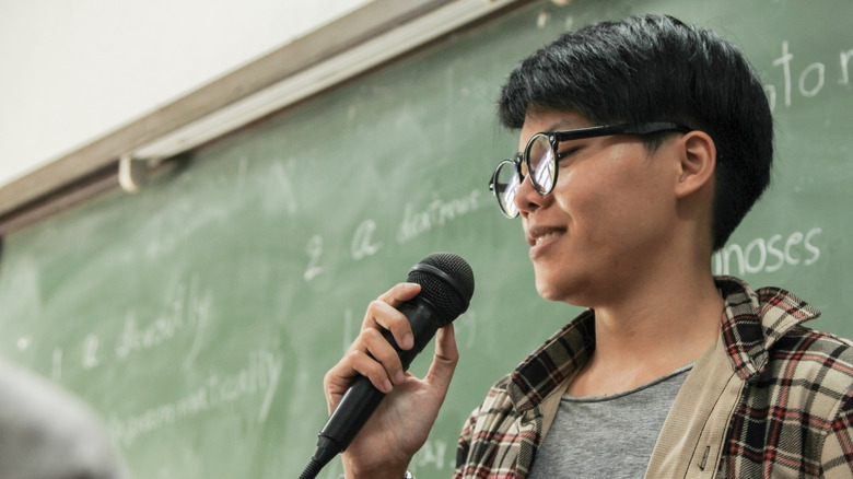 Student speaking into microphone