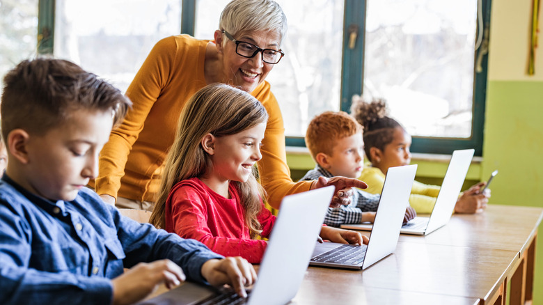 Teacher with students on laptops