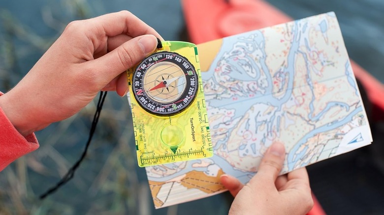 Person using the Orienteering Compass with a map.