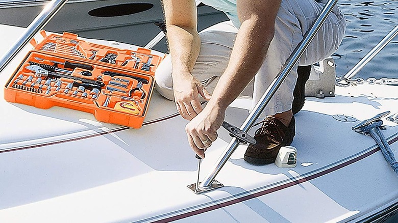 Person using the MS125 tool kit to repair a boat railing.