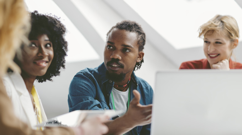 Man and women discussing computer