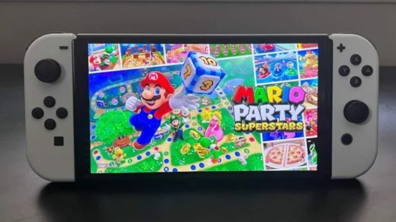 A Nintendo Switch OLED model playing Mario Party Superstars 