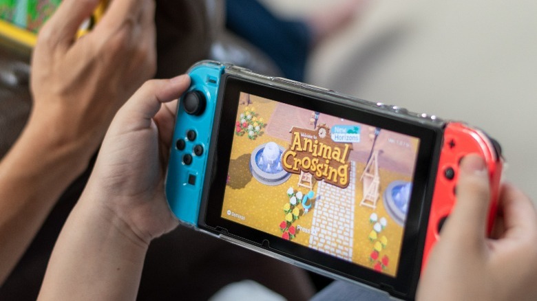 A gamer playing Animal Crossing on Nintendo Switch
