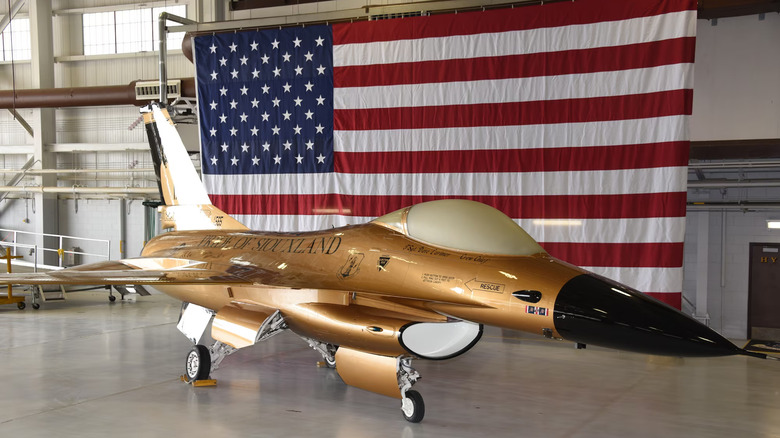 F-16 Fighting Falcon with gold retro paint job in hanger