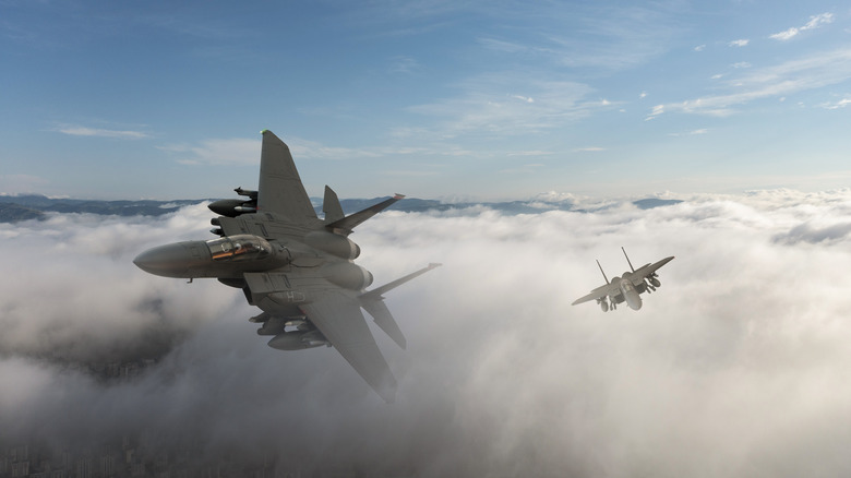 Two fighter jets against a cloudscape.