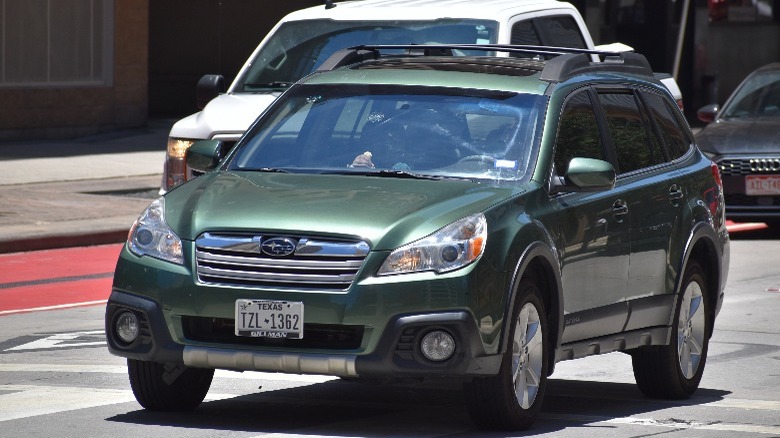 A green Subaru Outback